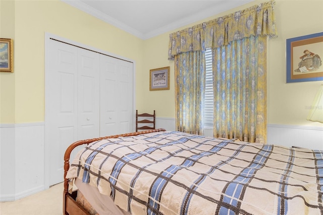 carpeted bedroom featuring a closet and ornamental molding