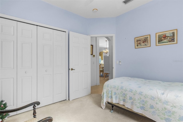 bedroom featuring a closet and light colored carpet