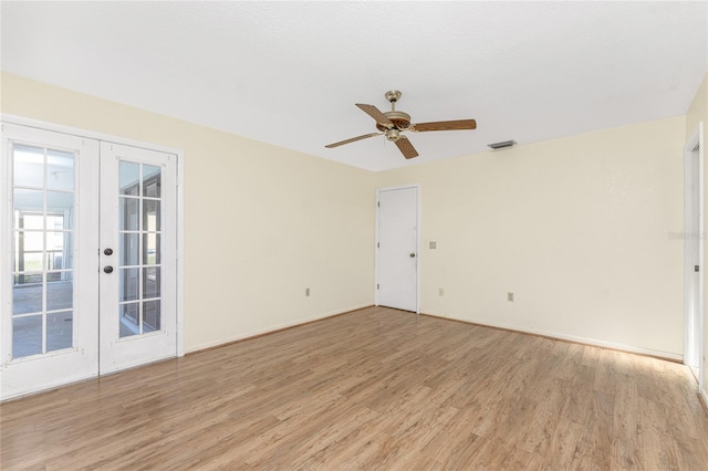 empty room with french doors, light hardwood / wood-style flooring, and ceiling fan