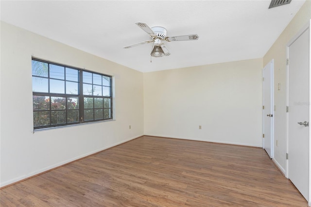 unfurnished room with hardwood / wood-style flooring and ceiling fan