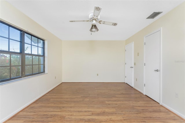 empty room with light hardwood / wood-style floors and ceiling fan