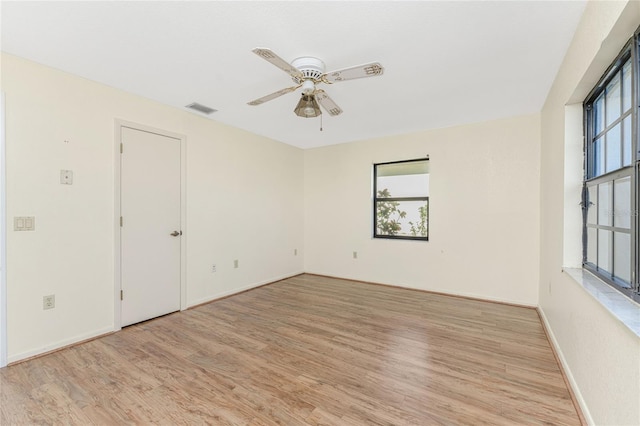 empty room featuring ceiling fan and light wood-type flooring