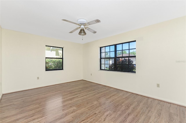 empty room featuring light wood-type flooring and ceiling fan