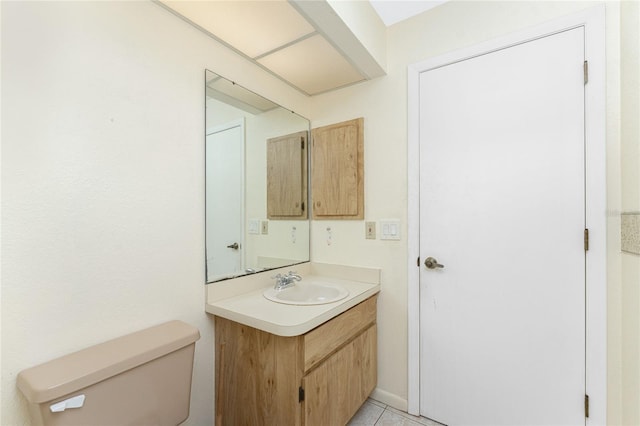 bathroom with tile patterned flooring, vanity, and toilet