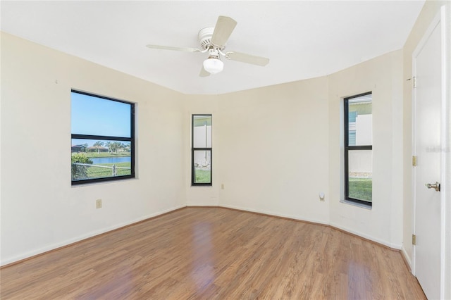 spare room with light hardwood / wood-style flooring and ceiling fan