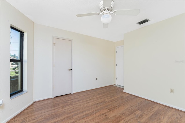 spare room with ceiling fan and wood-type flooring