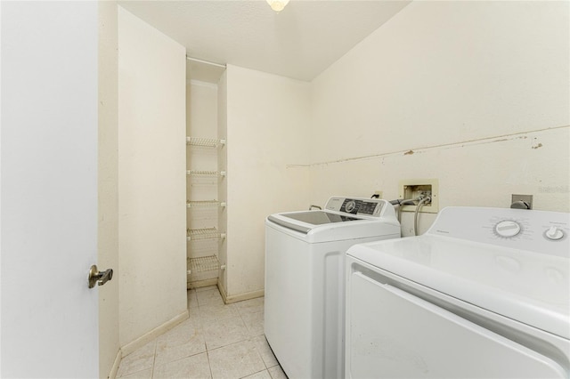 laundry area featuring light tile patterned floors and washing machine and clothes dryer