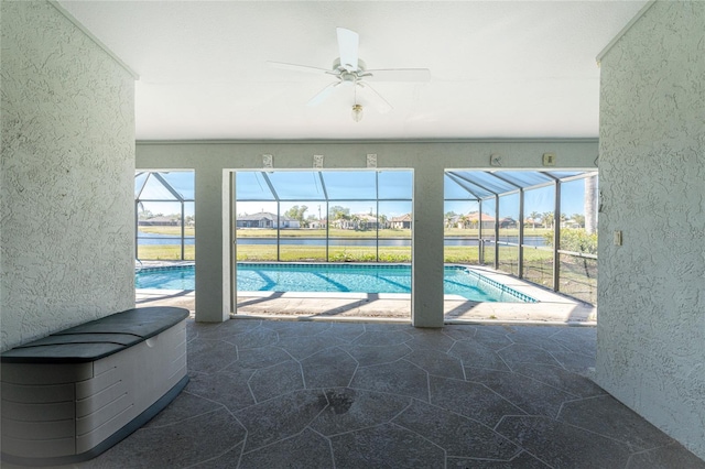 view of pool featuring ceiling fan and a water view