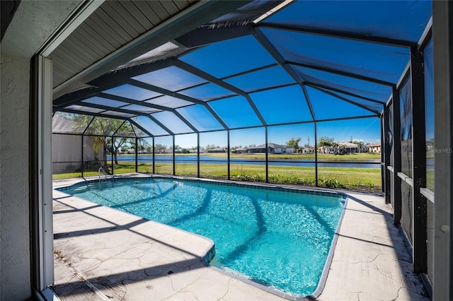 view of pool with glass enclosure and a patio