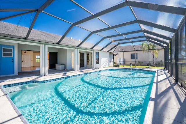 view of pool featuring glass enclosure, a patio area, and french doors