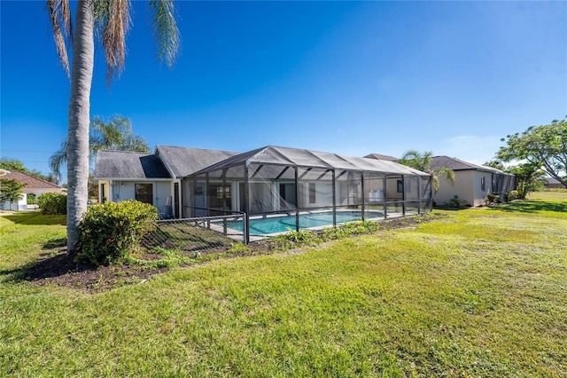 view of pool with a lanai and a lawn