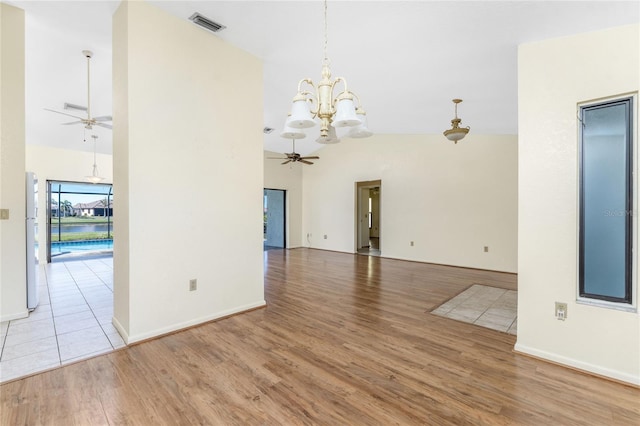 interior space featuring light hardwood / wood-style flooring, high vaulted ceiling, and ceiling fan with notable chandelier