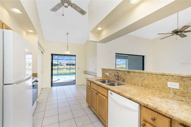 kitchen featuring backsplash, sink, a healthy amount of sunlight, and white appliances