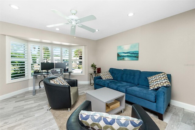 living room featuring ceiling fan and light hardwood / wood-style floors