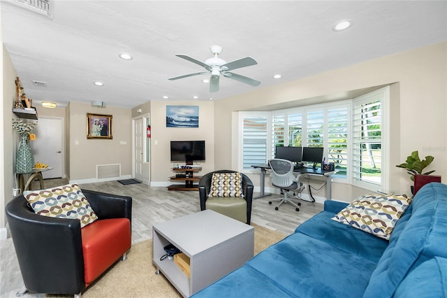 living room with ceiling fan and light hardwood / wood-style floors