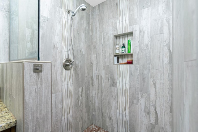 bathroom featuring a shower with shower door