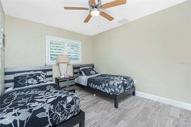 bedroom with ceiling fan and light hardwood / wood-style floors