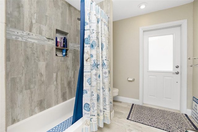 bathroom featuring hardwood / wood-style floors, toilet, and shower / bath combo with shower curtain