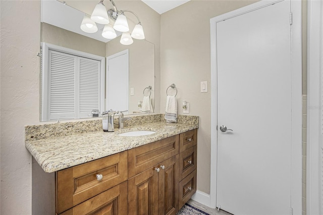 bathroom with vanity and a notable chandelier