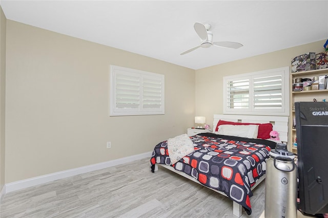 bedroom with light wood-type flooring and ceiling fan