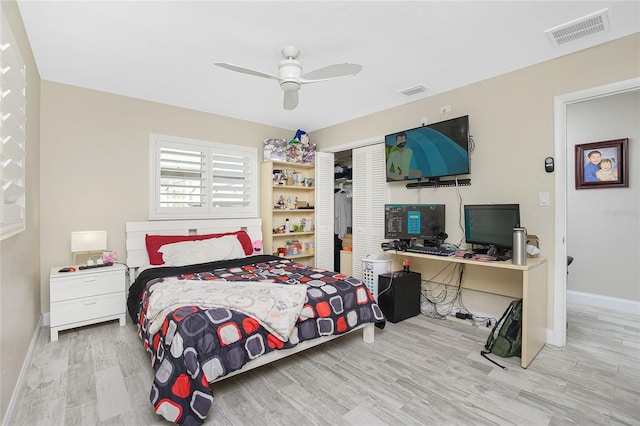 bedroom featuring ceiling fan, a closet, and light hardwood / wood-style floors