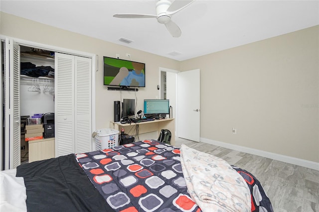 bedroom with ceiling fan, a closet, and light hardwood / wood-style flooring