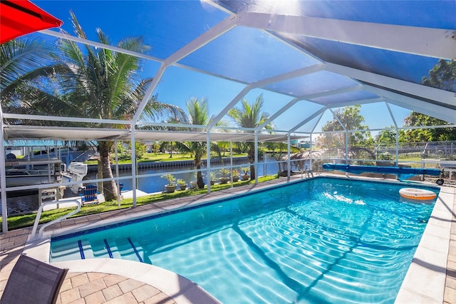 view of swimming pool with a water view and a lanai