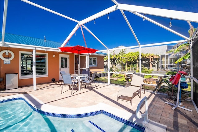 view of patio / terrace featuring a lanai