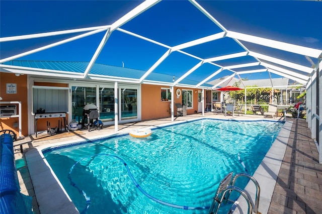 view of swimming pool with area for grilling, a patio, and glass enclosure