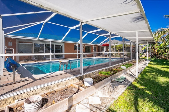 view of pool featuring glass enclosure, a patio area, and a yard