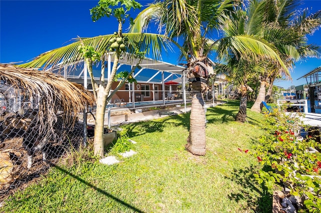 view of yard featuring a pool and glass enclosure