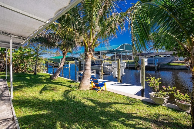 dock area featuring a water view and a lawn