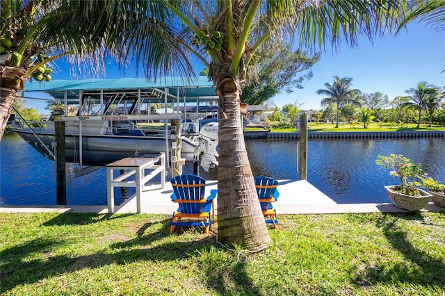 dock area with a lawn and a water view