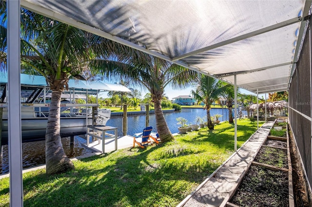 exterior space featuring a lawn and a water view