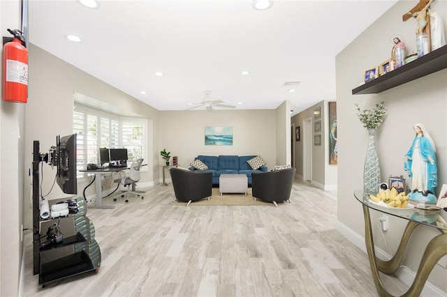 living room with ceiling fan and light hardwood / wood-style flooring