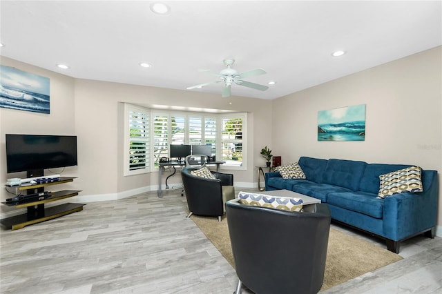 living room featuring ceiling fan and light hardwood / wood-style floors