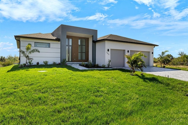 contemporary house featuring a front lawn and a garage