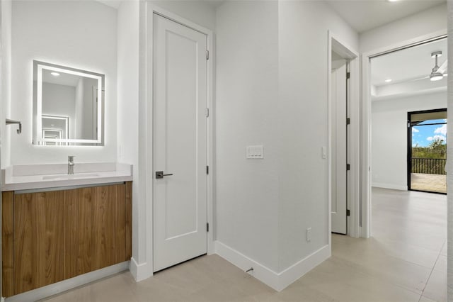 hallway with sink and light tile patterned floors