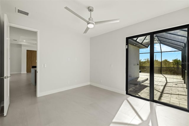 tiled spare room featuring ceiling fan