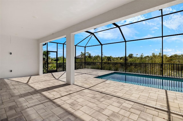 view of swimming pool featuring a lanai and a patio area