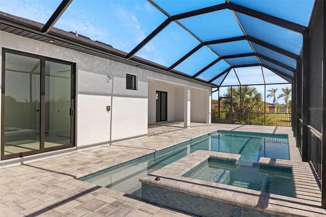 view of swimming pool with glass enclosure, an in ground hot tub, and a patio