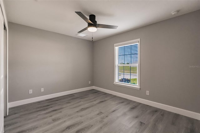 spare room with hardwood / wood-style flooring and ceiling fan