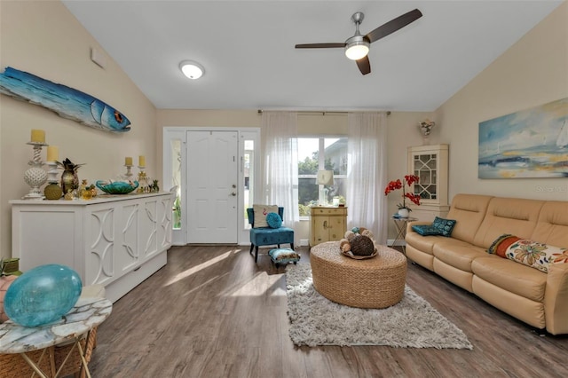 living room featuring ceiling fan, wood-type flooring, and vaulted ceiling