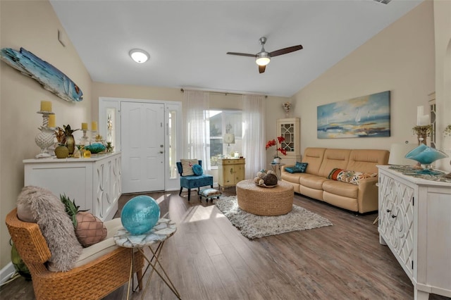 living room featuring ceiling fan, dark wood-type flooring, and lofted ceiling