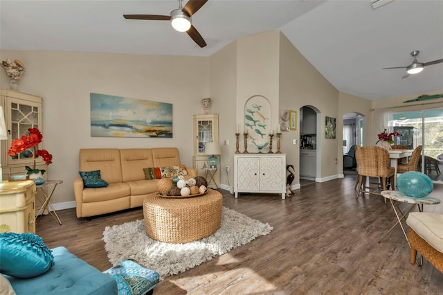 living room featuring dark hardwood / wood-style floors, ceiling fan, and vaulted ceiling