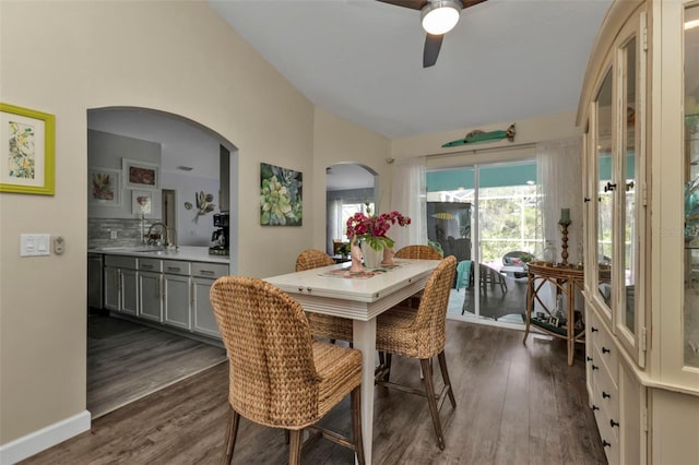 dining space featuring ceiling fan, dark hardwood / wood-style flooring, and sink