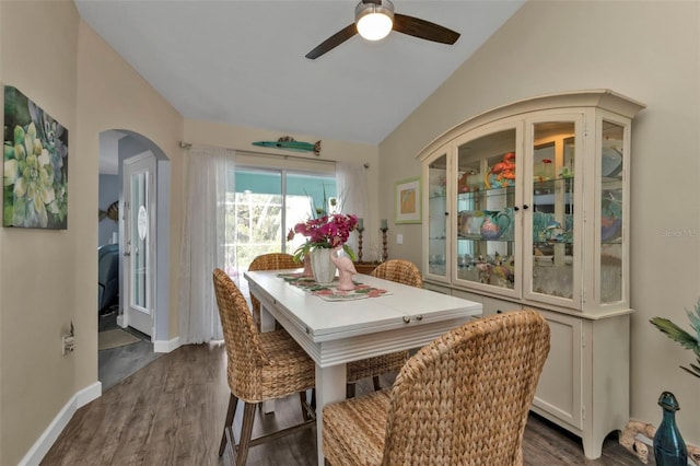 dining room featuring ceiling fan, dark hardwood / wood-style flooring, and lofted ceiling