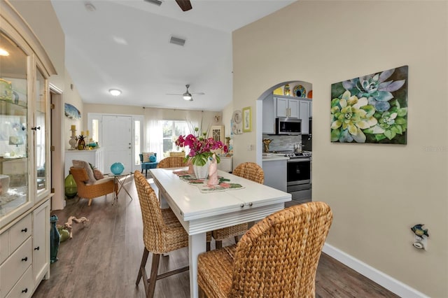 dining area featuring ceiling fan, dark hardwood / wood-style flooring, and lofted ceiling