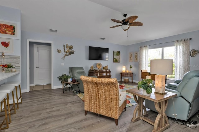 living room featuring hardwood / wood-style floors and ceiling fan