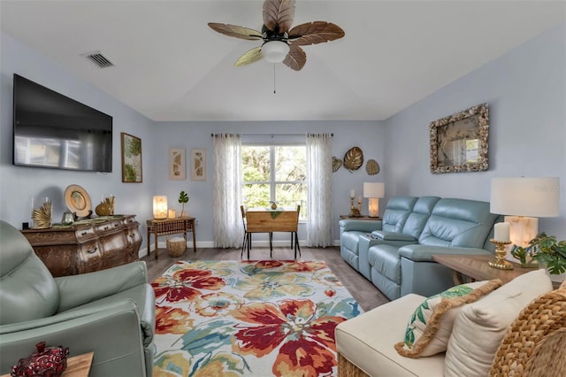 living room featuring ceiling fan and light hardwood / wood-style flooring